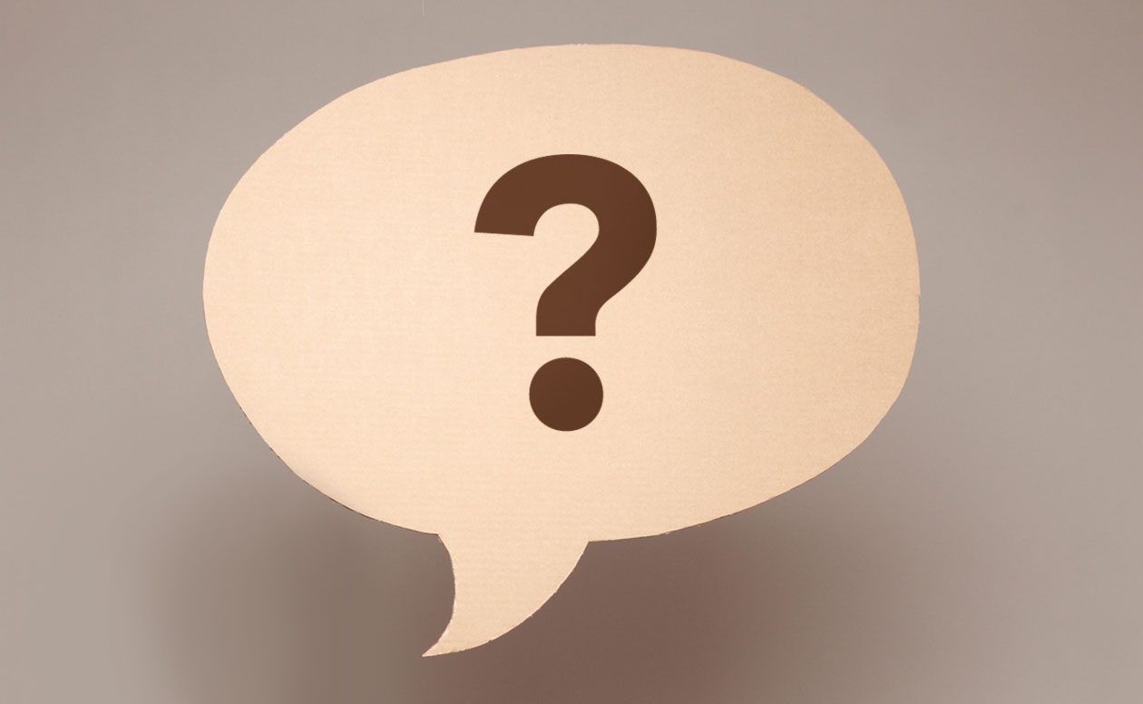 Cut out paper speech bubble with a question mark inside