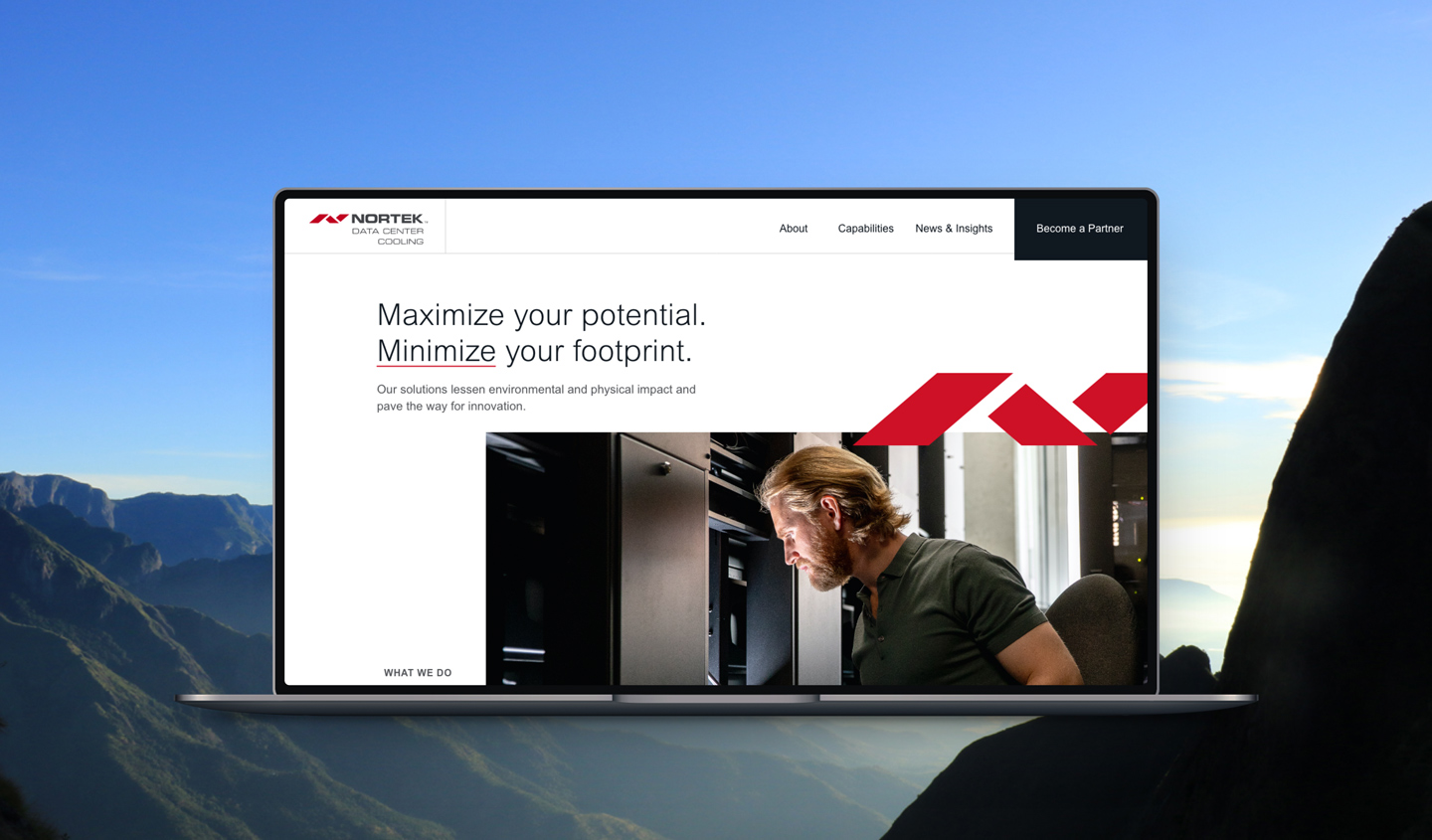 A laptop with the new Nortek Data Center Cooling website design in front of a mountain view
