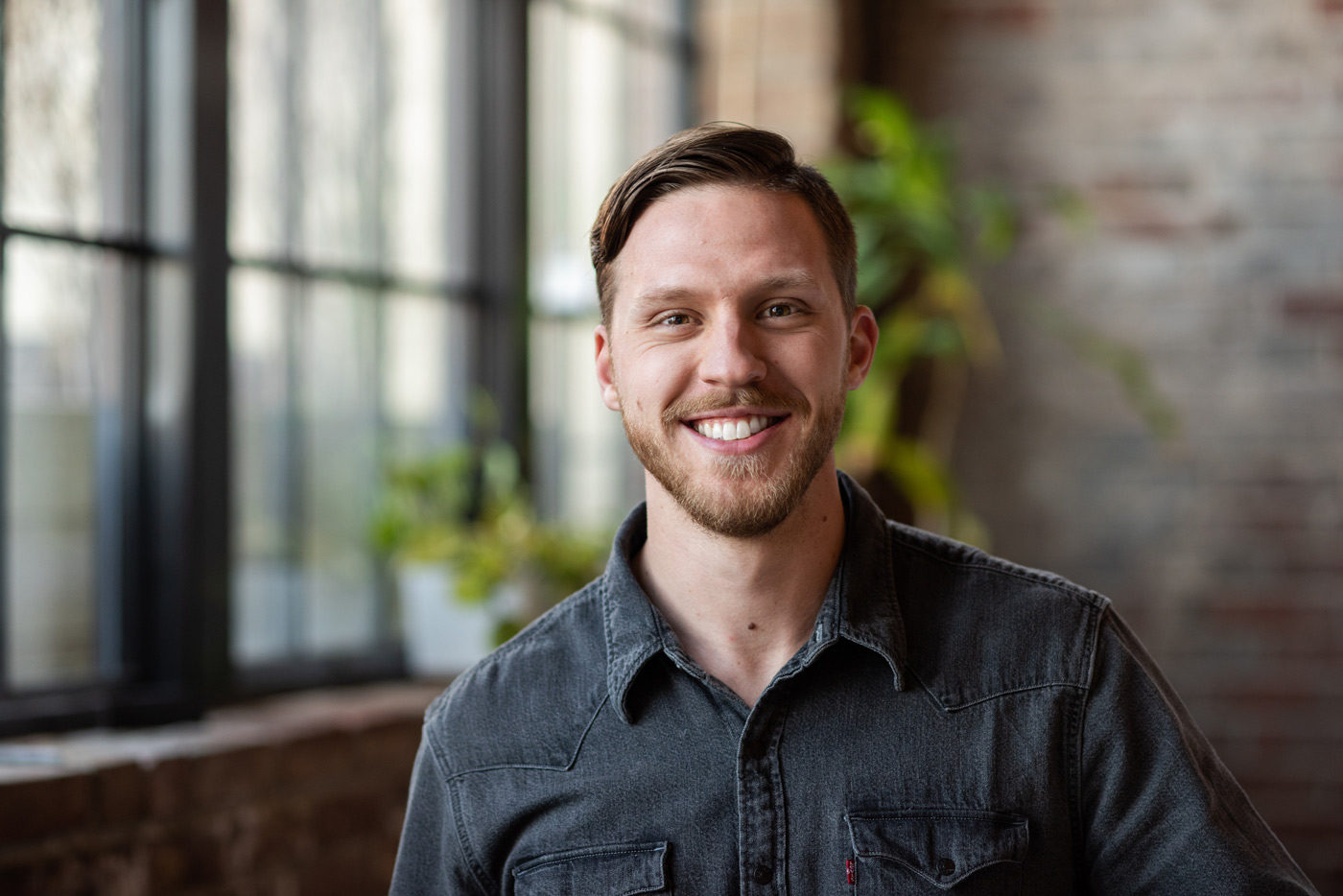 Sam Heaton smiles in the Atomicdust office