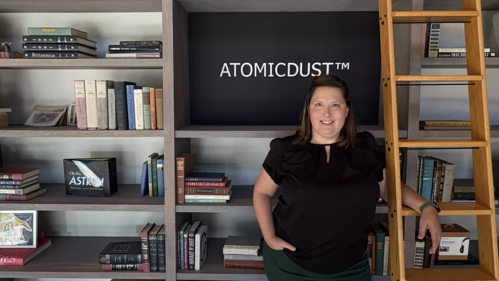 Angie hangs out by the bookshelves front of the Atomicdust office