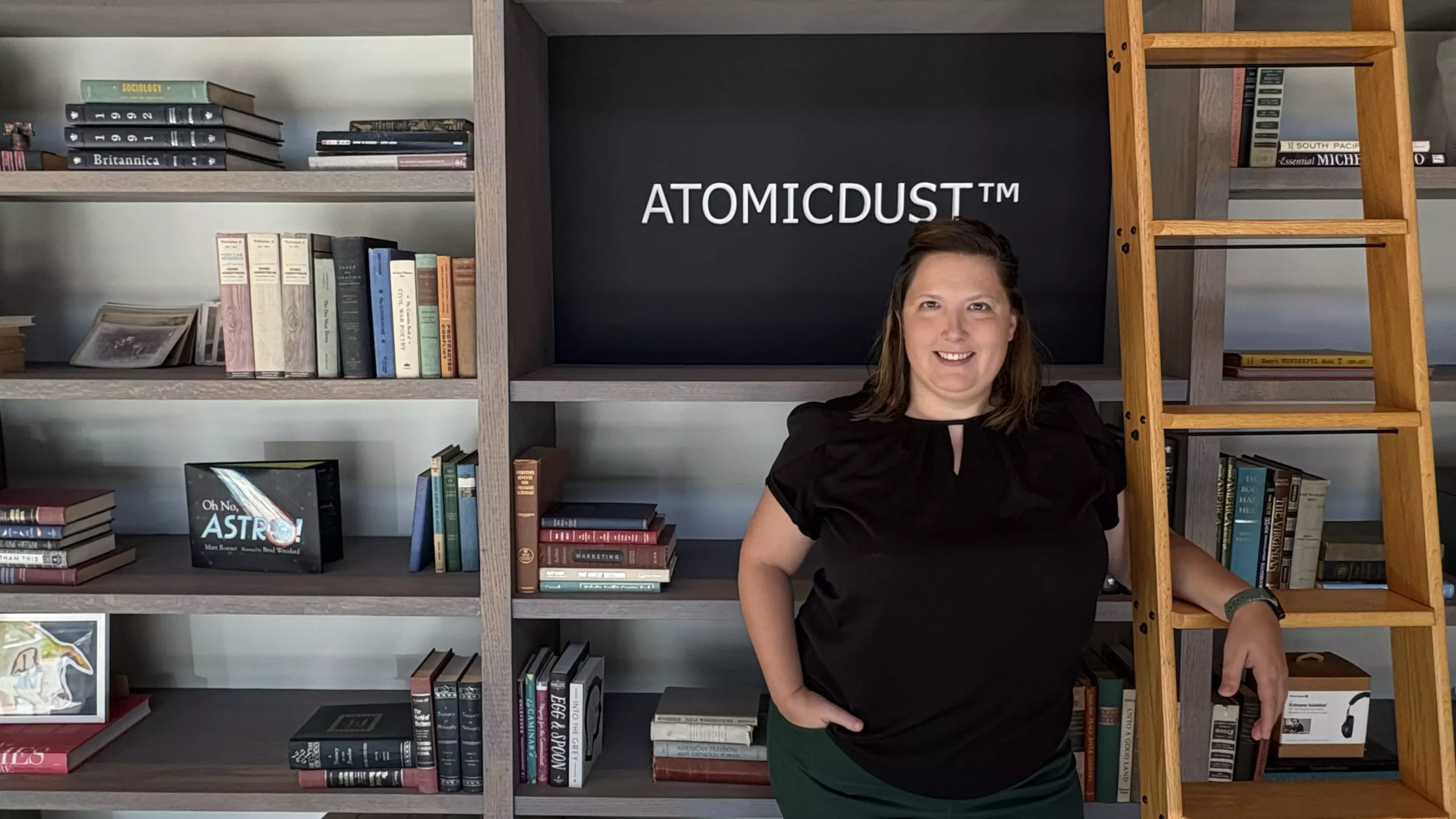 Angie hangs out by the bookshelves front of the Atomicdust office