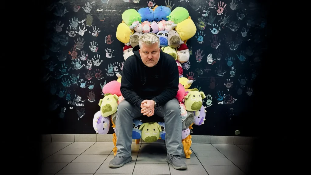 Mike Spakowski, Atomicdust founder and 2026 St. Louis TITAN 100 honoree, sits on a throne made of stuffed animals