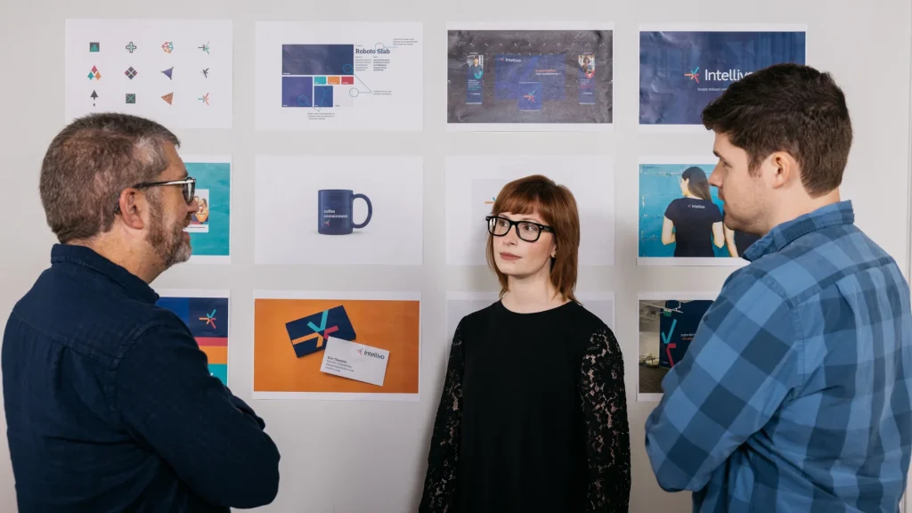 Atomicdust team reviewing brand identity design work