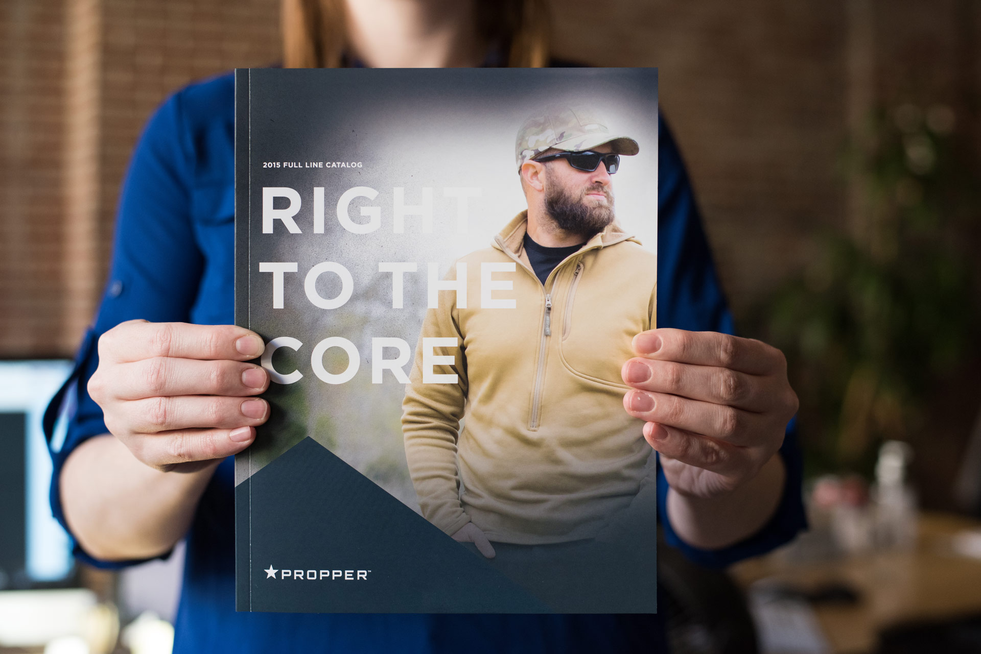 Designer holding the Propper branded catalog