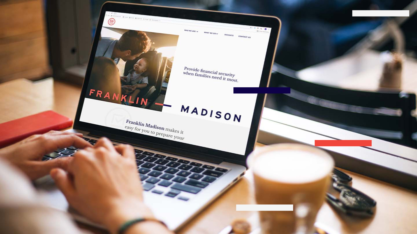 Franklin Madison website on a laptop in a cafe