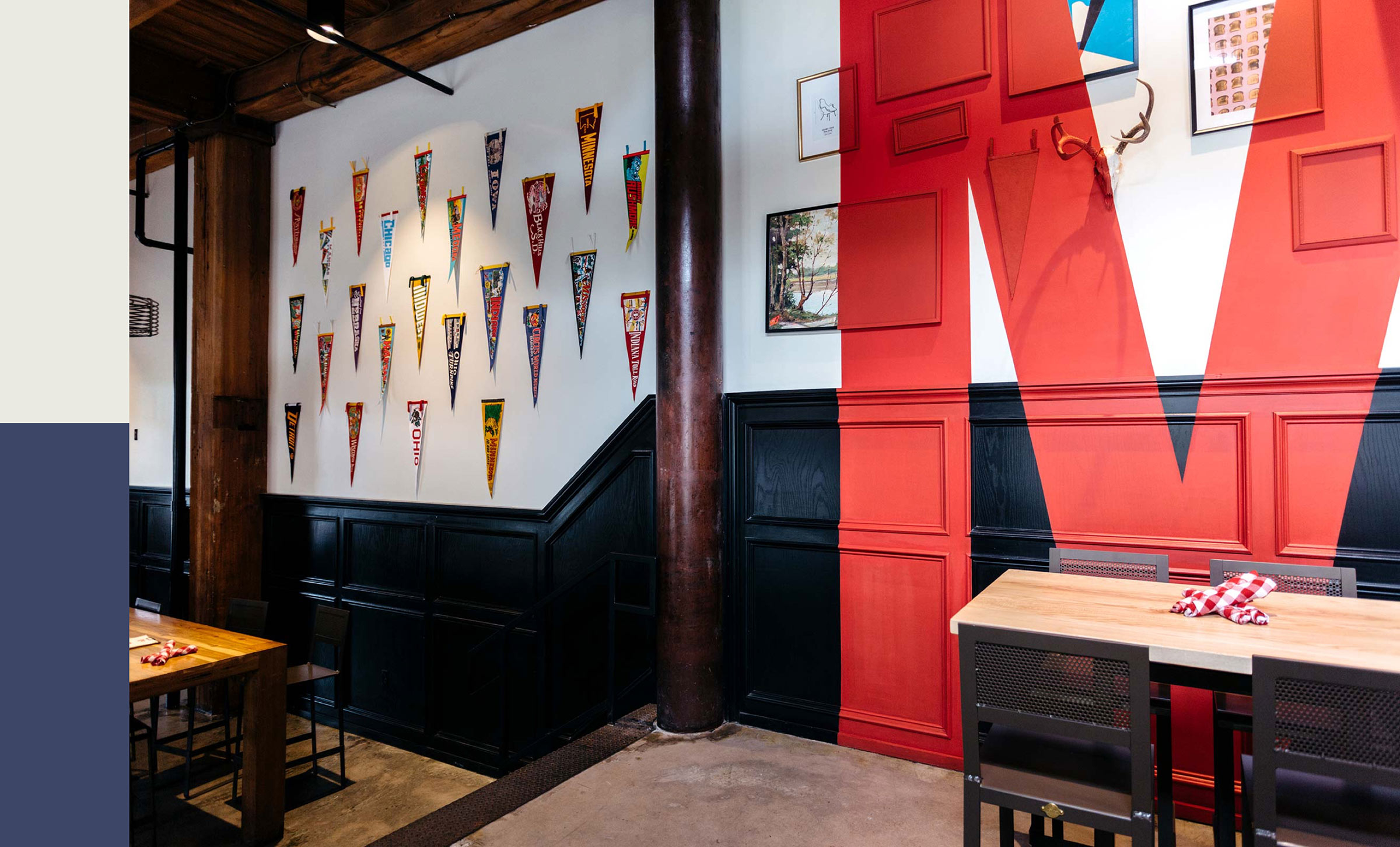 Restaurant branding large "M" mural and vintage pennants