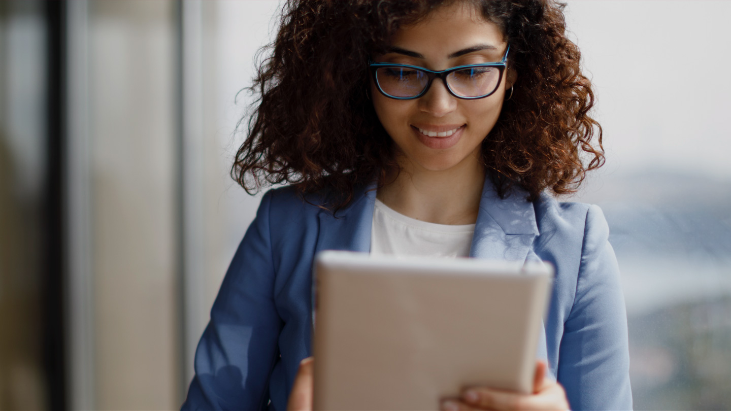 A woman looks at a tablet
