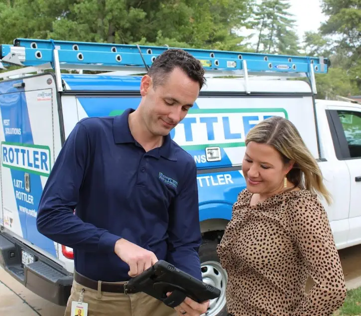 Rottler Pest Solutions employee talking with a customer
