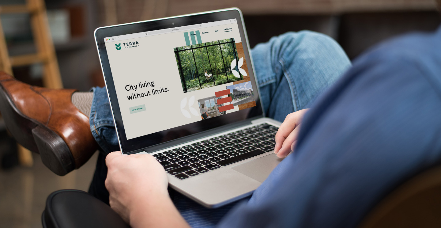 A person looks at the Terra Union branding on a website mockup