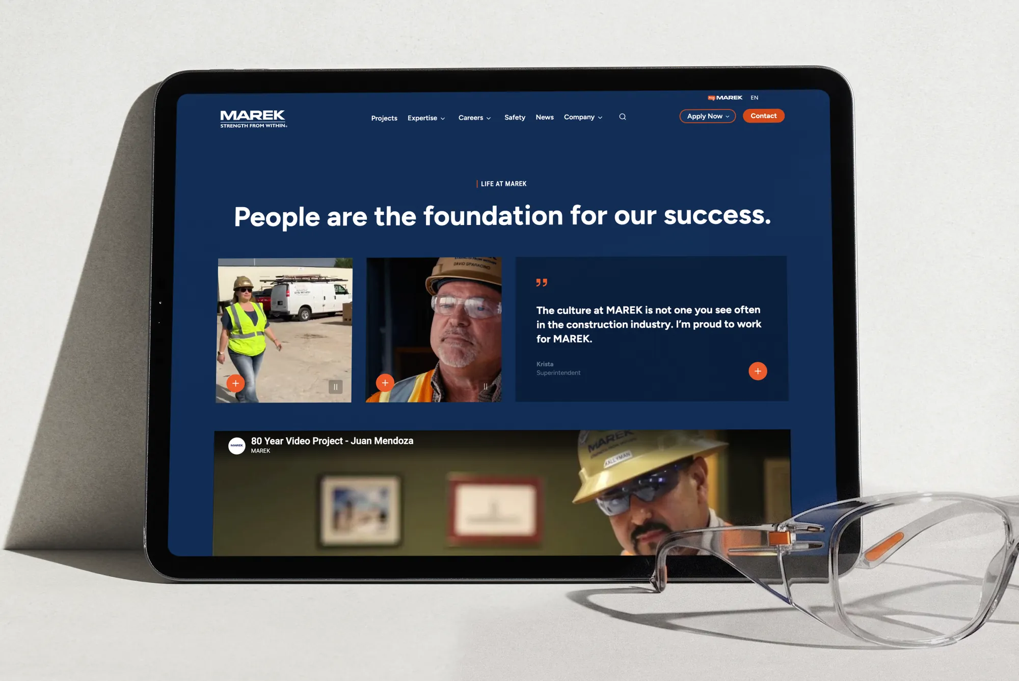 iPad displaying the MAREK website careers page with employee video testimonials
