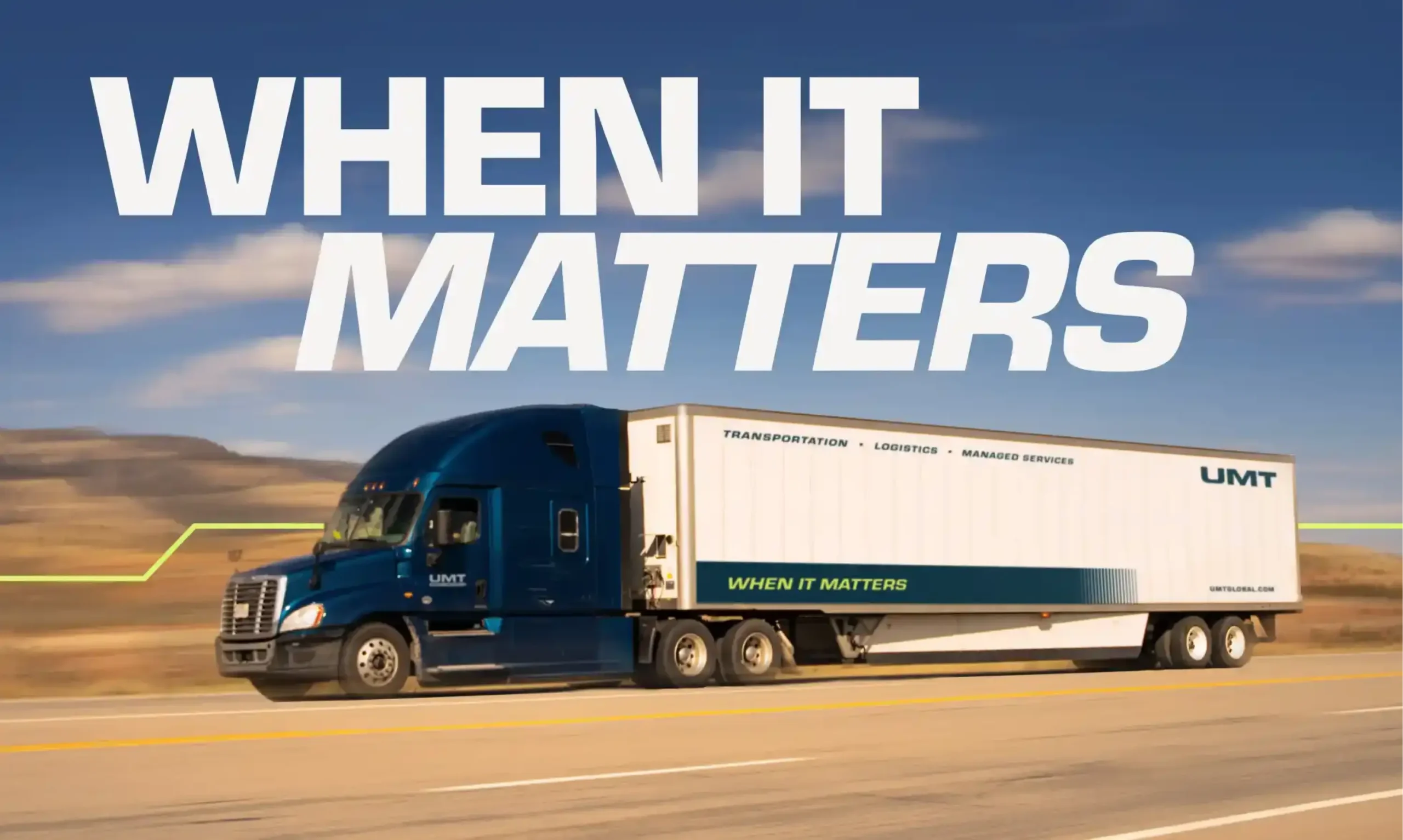 UMT tractor-trailer with the new brand identity and “When It Matters” tagline driving down a highway