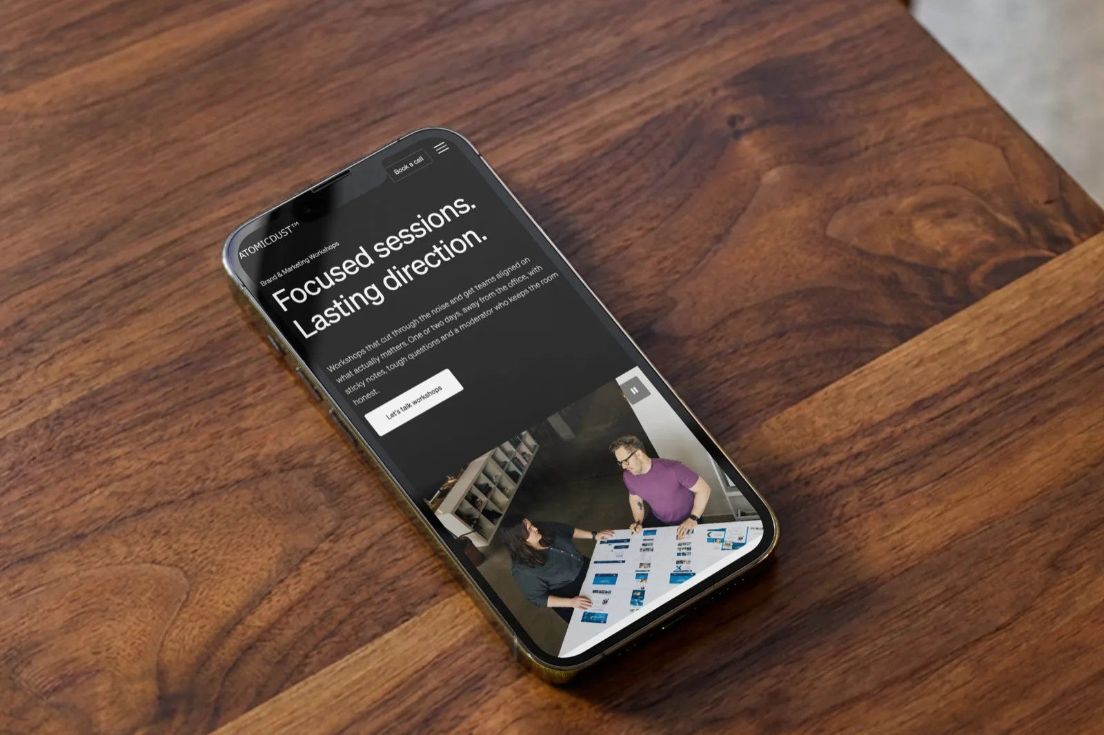 Atomicdust's Brand & Marketing Workshops page on a phone, headlined 'Focused sessions. Lasting direction'