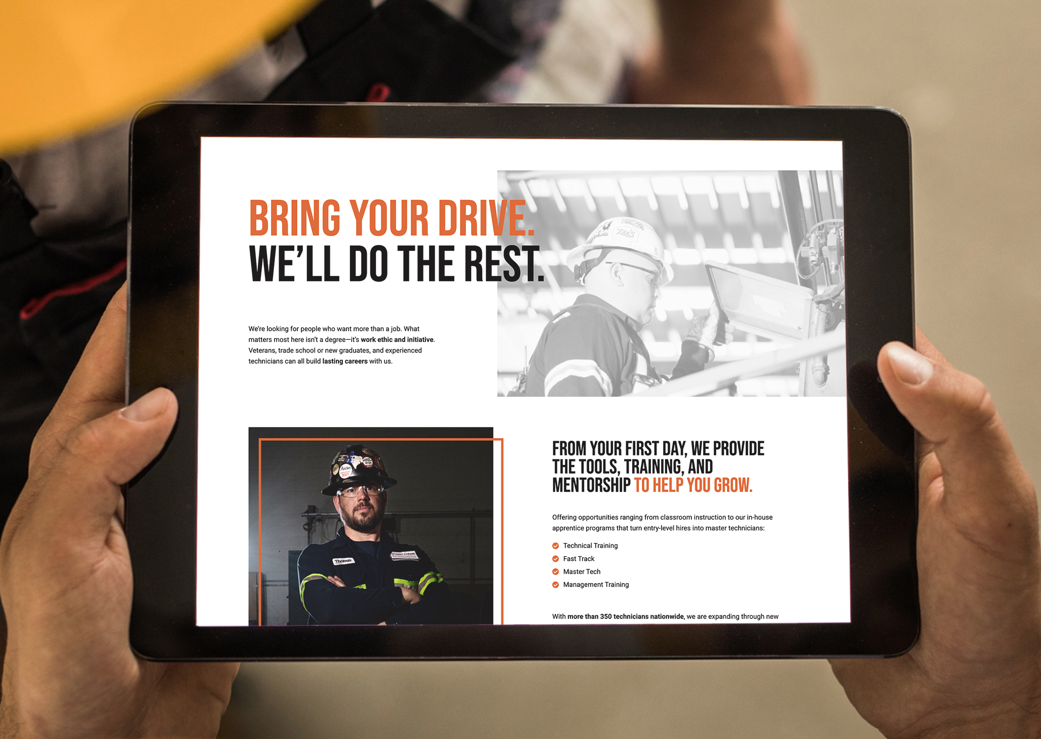 Hands holding a tablet showing the Hoist & Crane careers page reading "Bring your drive. We'll do the rest." with technician photos and training program details