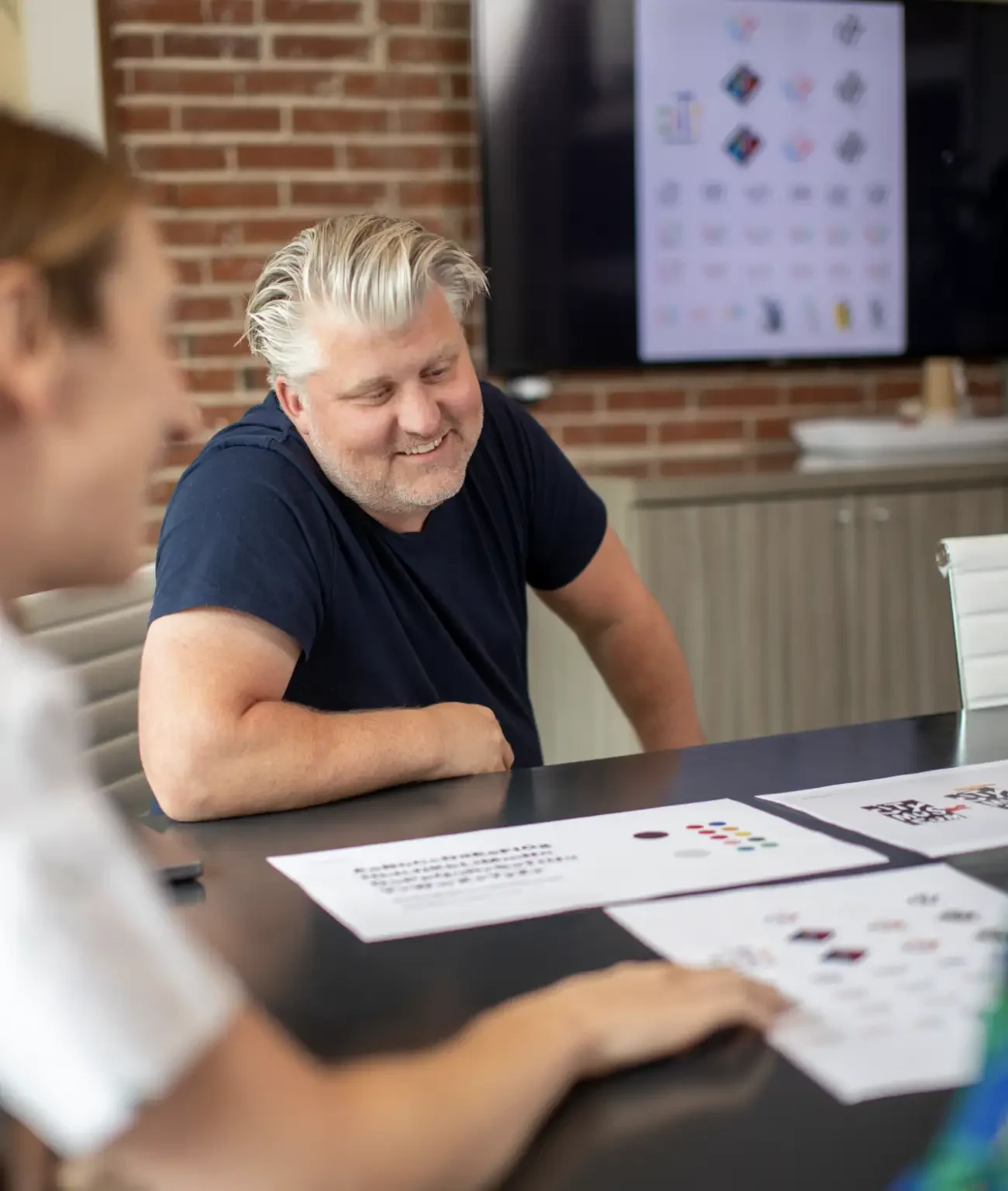 Creatives at Atomicdust reviewing branding work